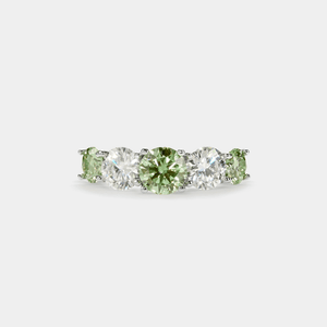 A five-stone color moissanite cocktail ring with alternating pink andlessen clear stones, set in a silver band with hypoallergenic plating.
