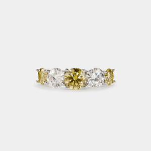 A five-stone color moissanite cocktail ring with alternating pink andlessen clear stones, set in a silver band with hypoallergenic plating.
