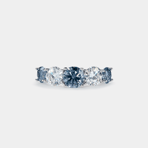 A five-stone color moissanite cocktail ring with alternating pink andlessen clear stones, set in a silver band with hypoallergenic plating.