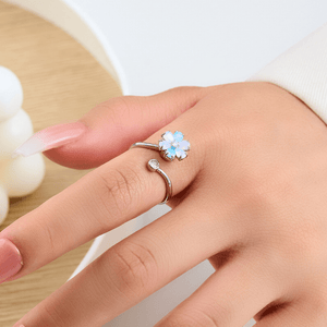 Silver ring with a flower-shaped gemstone on a hand