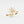 Gold ring with diamond flower design on a light gray background