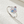 Silver ring with multicolored gemstones on a textured white surface