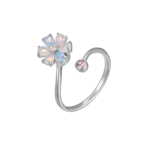 Silver ring with a flower-shaped gem on a white background