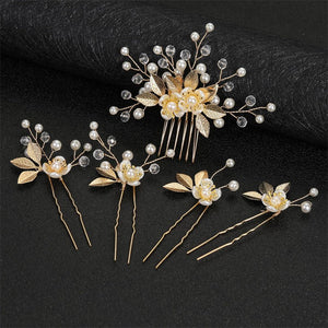 Set of gold hairpins with pearls and flowers on a black background