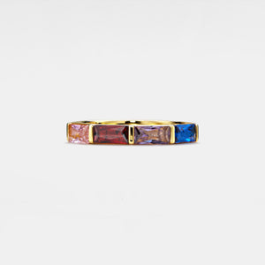Gold ring with multicolored gemstones on a white background