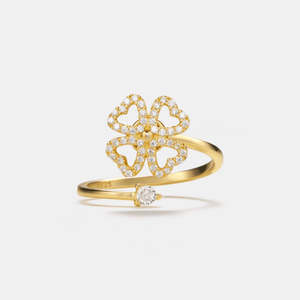 Gold ring with butterfly design and diamonds on a light gray background