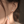 Close-up of a person wearing a delicate earring with a blurred background