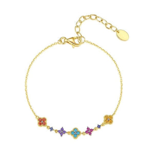 A gold-plated sterling silver bracelet with an adjustable chain and multiple multicolored four-leaf clover charms.
