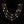 Gold necklace with floral pendants on a black background
