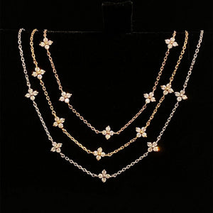 Gold necklace with floral pendants on a black background