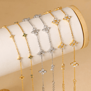 Three gold and silver necklaces with star-shaped pendants on a beige background