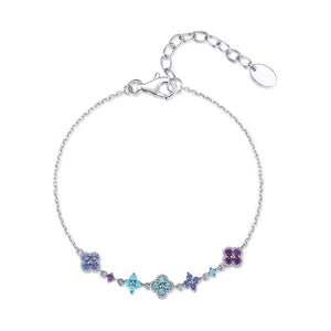 A gold-plated sterling silver bracelet with an adjustable chain and multiple multicolored four-leaf clover charms.