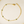 Gold bracelet with green gemstones on a light background