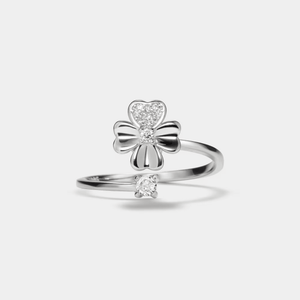 A gold-colored fidget spinner ring with a four leaf clover design and a small cubic zirconia stone.