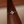 Gold ring with a diamond flower design on a wooden stand.
