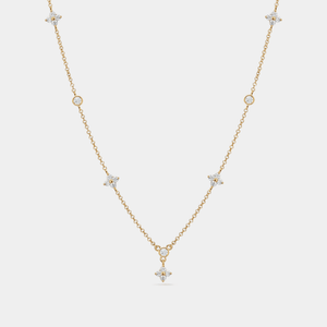 A gold-plated, sterling silver necklace with a chain design and a central four-petal flower-shaped cubic zirconia pendant.