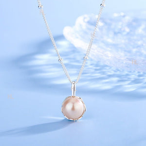 Pearl necklace on a blue background