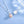 Pearl necklace with silver chain on a light blue background