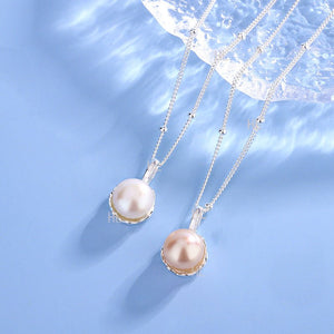 Two pearl necklaces on a light blue background