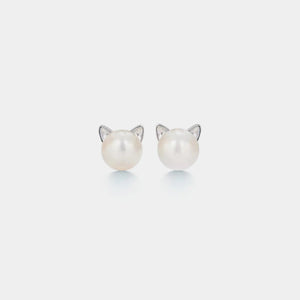 Pearl earrings with cat ear designs on a light gray background