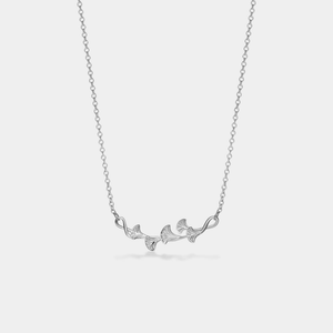 A gold-plated sterling silver necklace with a charm resembling a ginkgo leaf on a chain.