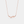 A gold-plated sterling silver necklace with a charm resembling a ginkgo leaf on a chain.