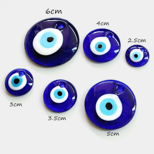 Set of blue evil eye charms with measurements on a white background
