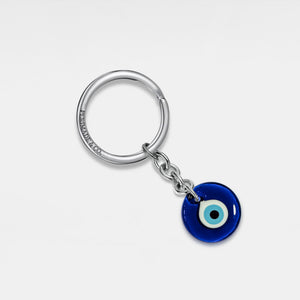 Keychain with a blue evil eye charm on a white background