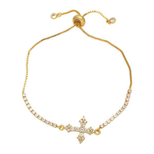 A gold-plated adjustable bracelet featuring a cross charm with cubic zirconia and small clear stones along the chain.