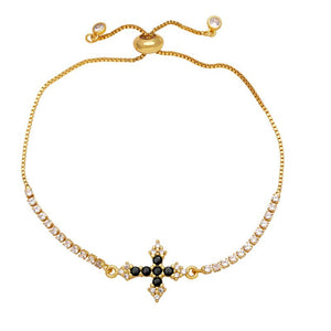 A gold-plated adjustable bracelet featuring a cross charm with cubic zirconia and small clear stones along the chain.