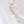 Gold ring with intricate design on a white marble surface