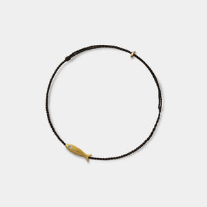 Necklace with a gold fish pendant on a white background
