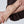 Close-up of a person's legs wearing sheer stockings on a white background