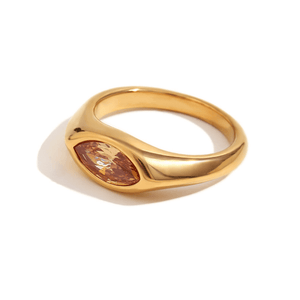 Gold ring with a brown gemstone on a white background