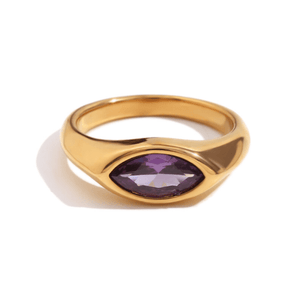 Gold ring with a purple gemstone on a white background