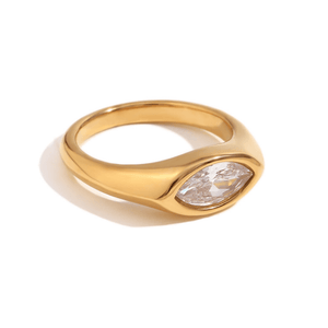 Gold ring with a clear gemstone on a white background