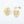 Gold leaf-shaped earrings with pearl centers on a light gray background