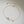 Gold bracelet with floral design on a light gray background