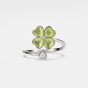 A gold-colored fidget spinner ring with a four-leaf clover design on the top and a small cubic zirconia stone.