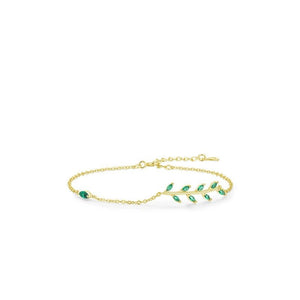 Gold bracelet with green gemstones on a white background