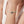 Bracelet with manta ray charm on a wrist against a neutral background