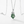 Green gemstone pendant on a silver chain against a white background