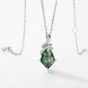 Green gemstone pendant on a silver chain against a white background