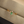 Gold ring with a green gemstone on a beige surface