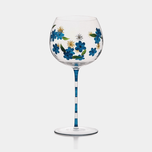 Wine glass with floral design on a white background