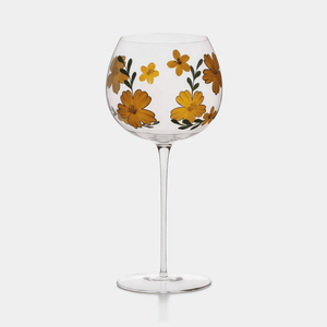 Wine glass with floral design on a white background