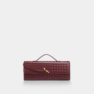 Maroon woven handbag with a gold clasp on a white background