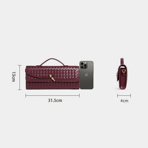 Red handbag with dimensions and an iPhone for scale on a white background