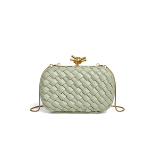Mint green woven handbag with gold accents on a white background