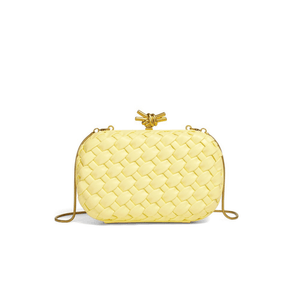 Yellow woven handbag with a gold clasp on a white background